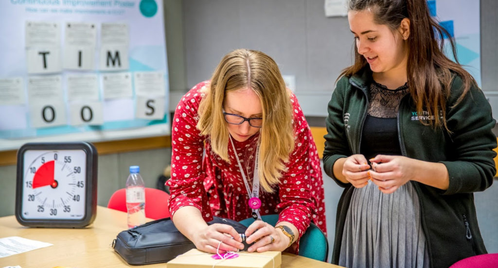 Two women working together at a table during the learn fest
